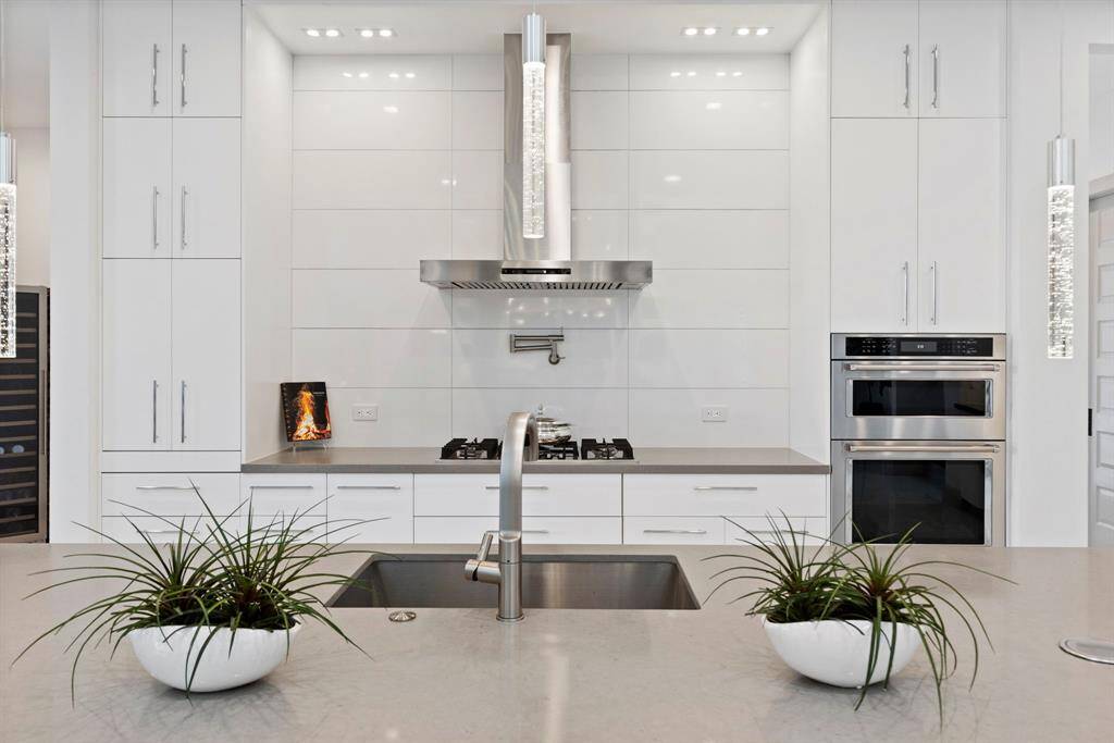 A commercial grade fridge/freezer, spacious island with additional seating are surrounded by custom cabinetry.