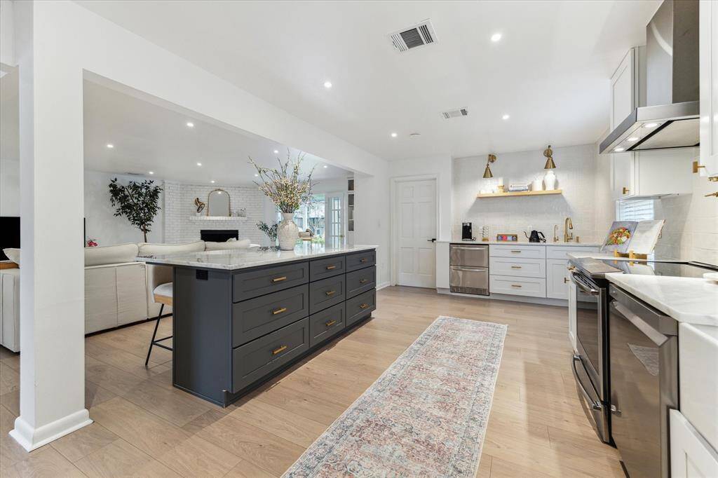 Alternative view of kitchen looking into living room, sunroom and beyond!