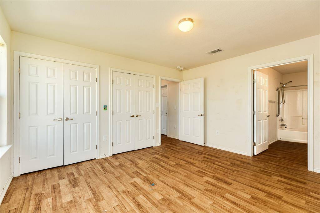 Primary bedroom with ensuite bathroom and large closets