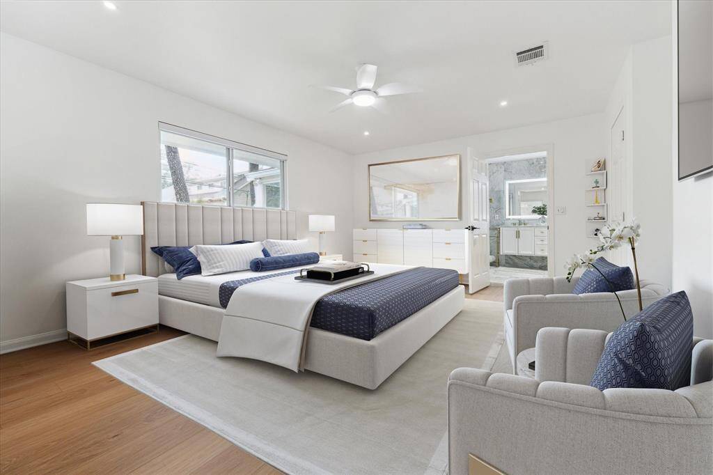 Primary bedroom (virtually staged) with ceiling fan, recessed lighting and tons of natural lighting