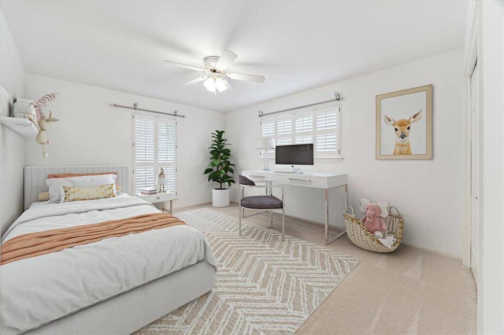 Secondary bedroom (virtually staged)with ceiling fan and fresh carpet.  This room leaves plenty of space for a desk area.
