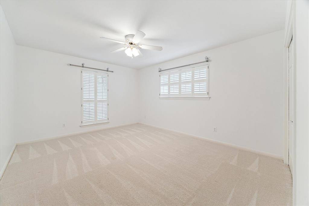 Secondary bedroom with two large closets and ceiling fan