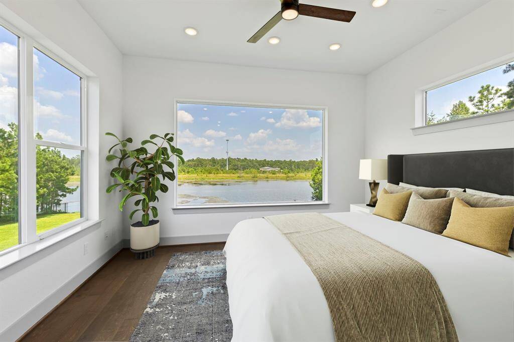 VS - Additional bedroom up is wrapped in relaxing window views of the lush green background and water.
