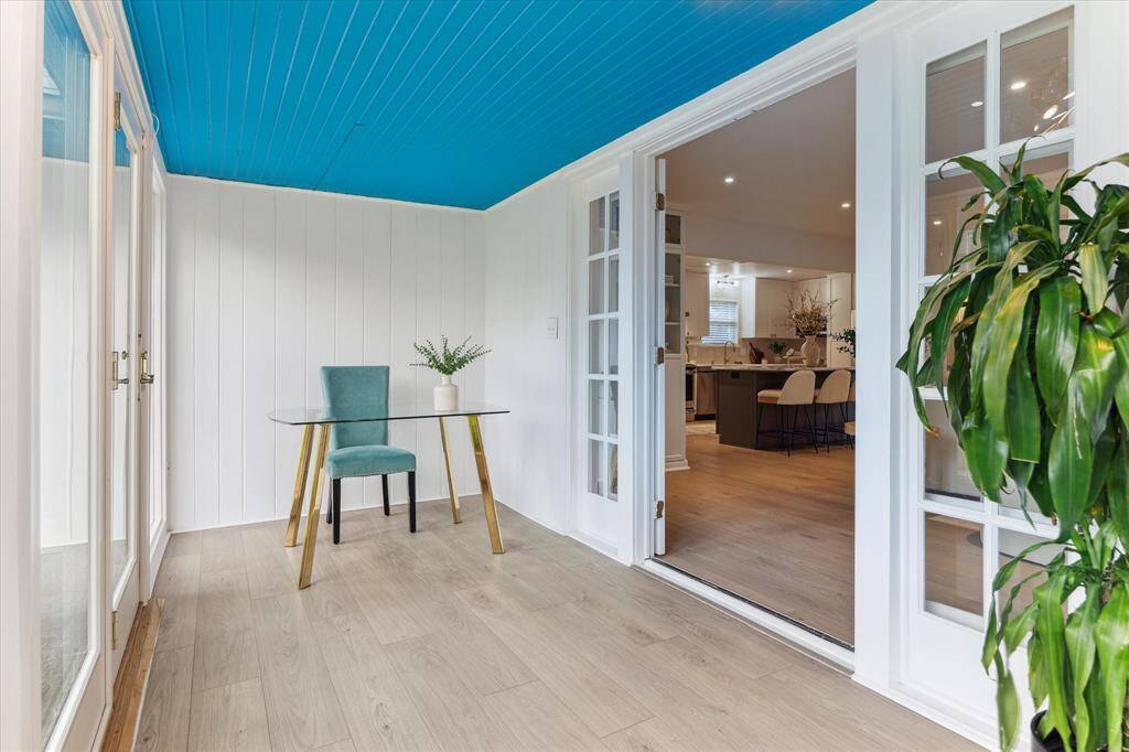 Adorable Sun room/flexible space with a wall of windows looking into the backyard and beyond!