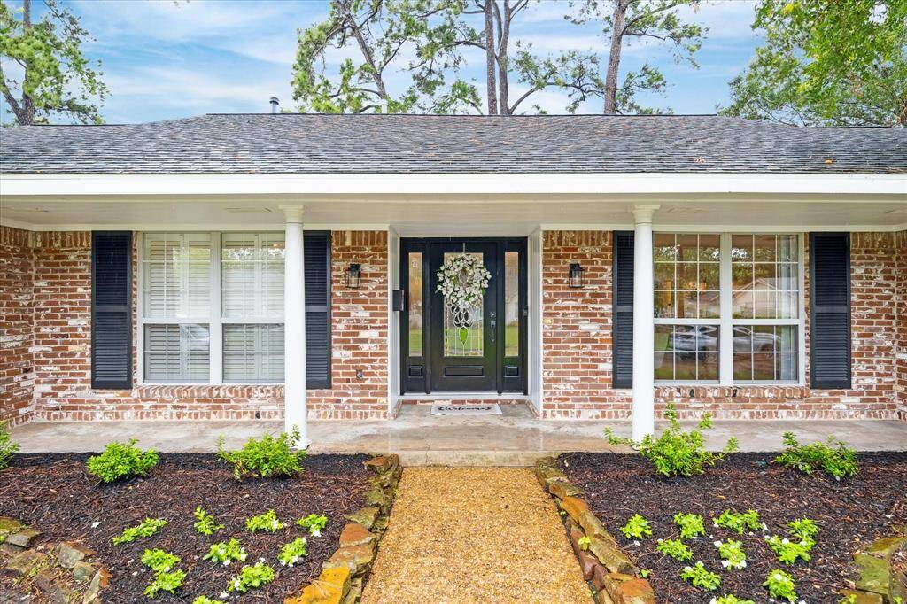Oversized front porch and professional landscape greet you