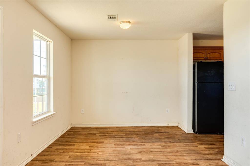 Dining room with galley kitchen on right