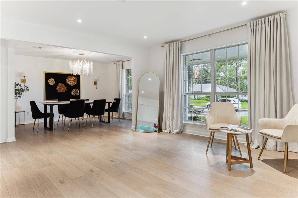 Appointed dining room with designer light fixtures is adjacent to seating area upon entry