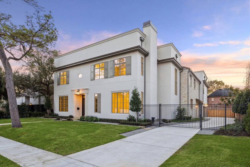 Great room boasts white oak ceiling details, plaster finishes, built in cabinetry, and a wall of windows overlooking the back yard.
