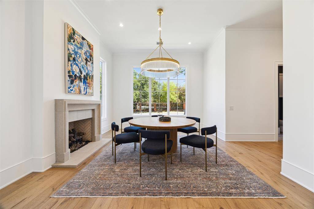 Dining room with gas log fireplace and cast stone surround