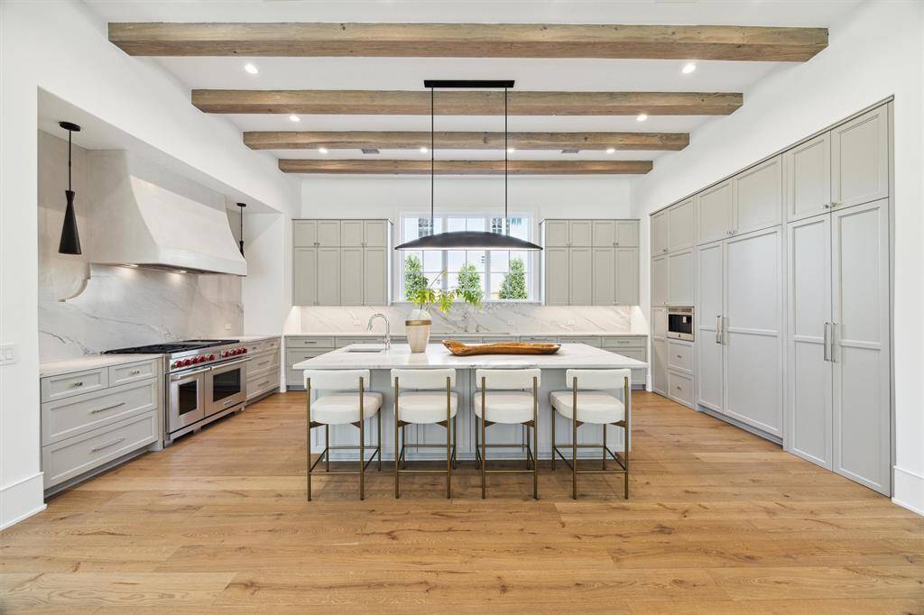 Chef's kitchen with multiple sinks, Wolf range, Subzero refrigeration, and a built in coffee station