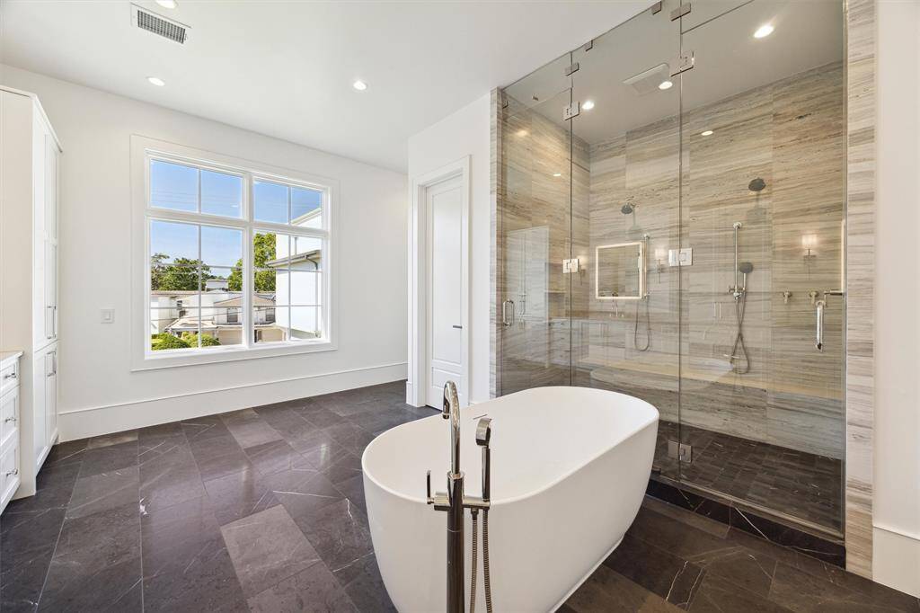 Custom finishes throughout.  His and Her waterclosets on each side of the shower.
