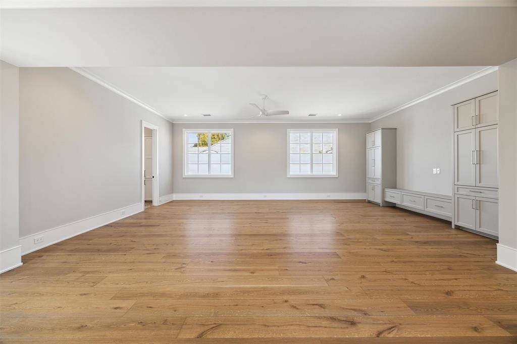 Game Room up with wall of built ins.  Plenty of room for a pool or shuffleboard table.