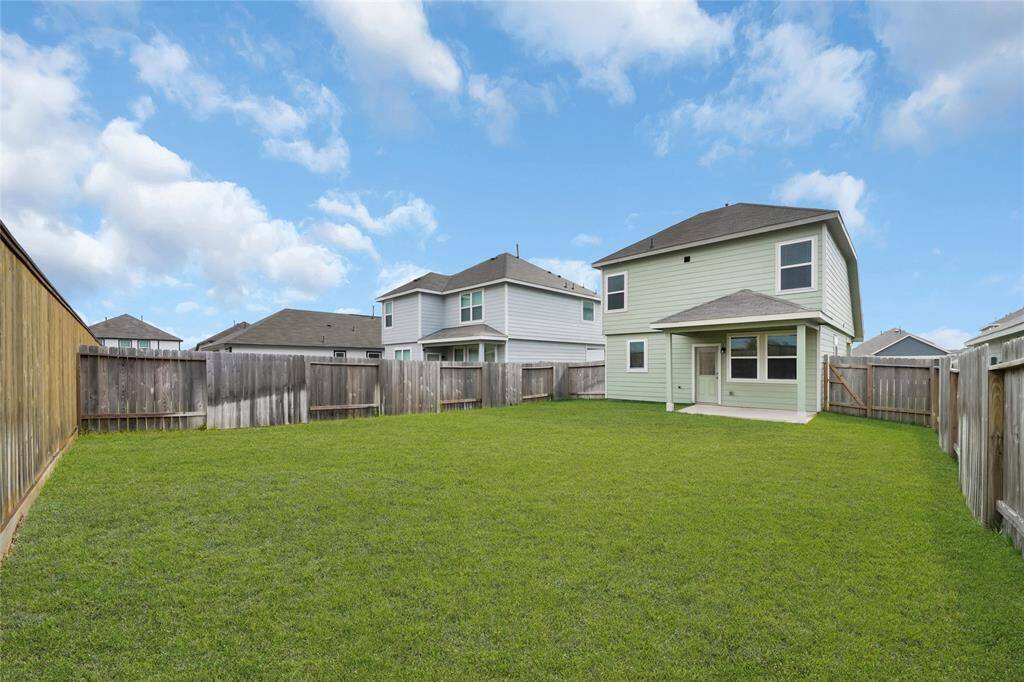 Relax in the shade on your covered back patio overlooking your beautiful yard. Welcome home!