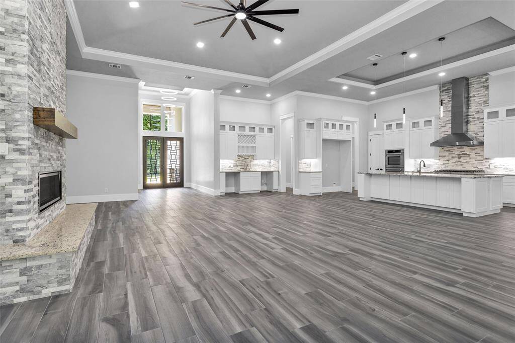 Open-concept design features a wet bar with space for both a wine fridge & beverage fridge, along with the space for a 60" built-in refrigerator.