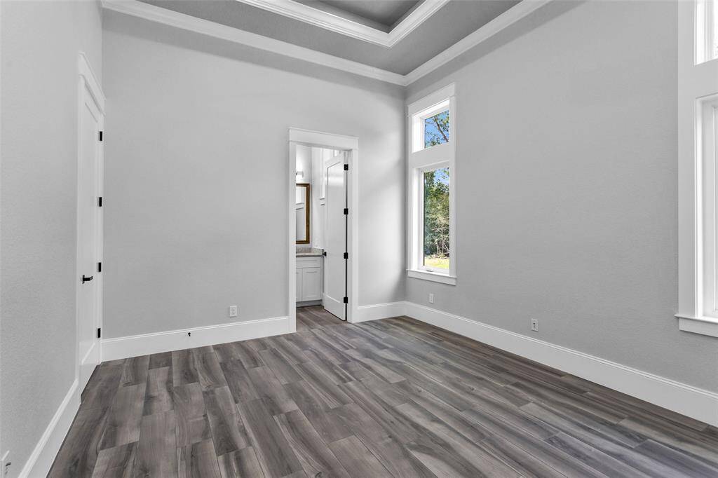 Bedroom #3. All Secondary Bedrooms are finished with casement windows with transoms, inset tray ceilings, incredible moldings and millwork, "wood" tile flooring, 2 locations of shielded CAT6A (Ethernet/Data) and shielded coaxial (TV) cables and En Suite Bathrooms.