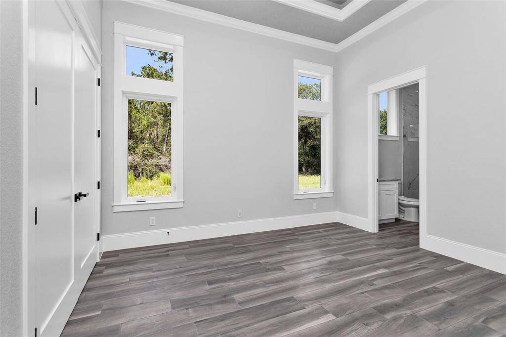 Bedroom #4. All Secondary Bedrooms are finished with casement windows with transoms, inset tray ceilings, incredible moldings and millwork, "wood" tile flooring, 2 locations of shielded CAT6A (Ethernet/Data) and shielded coaxial (TV) cables and En Suite Bathrooms.