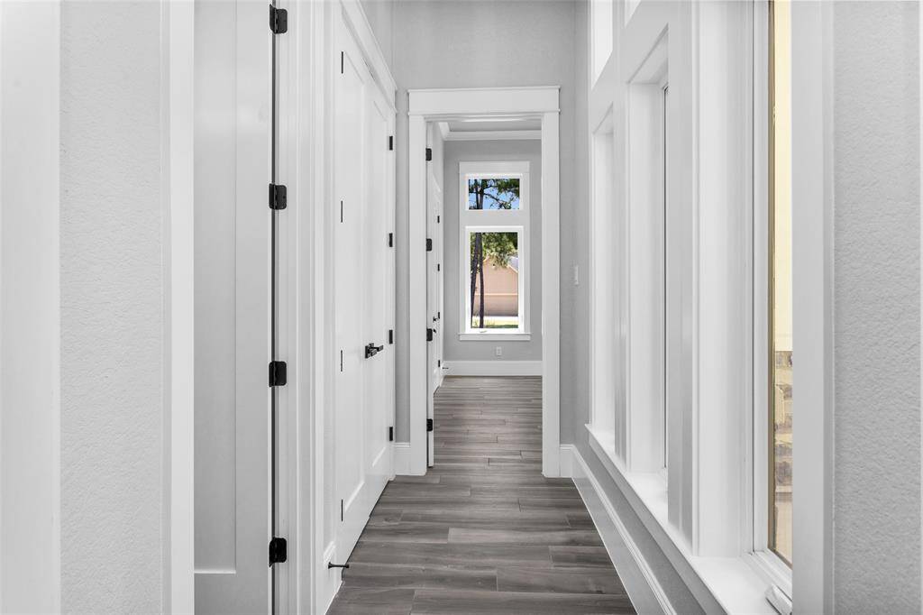 Bedroom #6 is located at the front of the home away from the other Secondary Bedrooms for a little more privacy, so it makes a perfect home office or guest suite.
