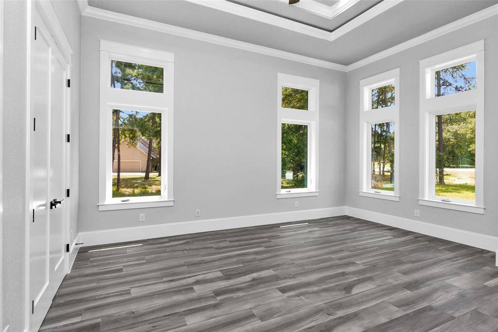 Bedroom #6 can also be used as an office, in-law suite or baby room, as it is on the same side of the home as the Primary Suite away from the other Secondary Bedrooms. It is also finished with casement windows with transoms, inset tray ceilings, incredible moldings and millwork, "wood" tile flooring, 2 locations of shielded CAT6A (Ethernet/Data) and shielded coaxial (TV) cables and En Suite Bathrooms.
