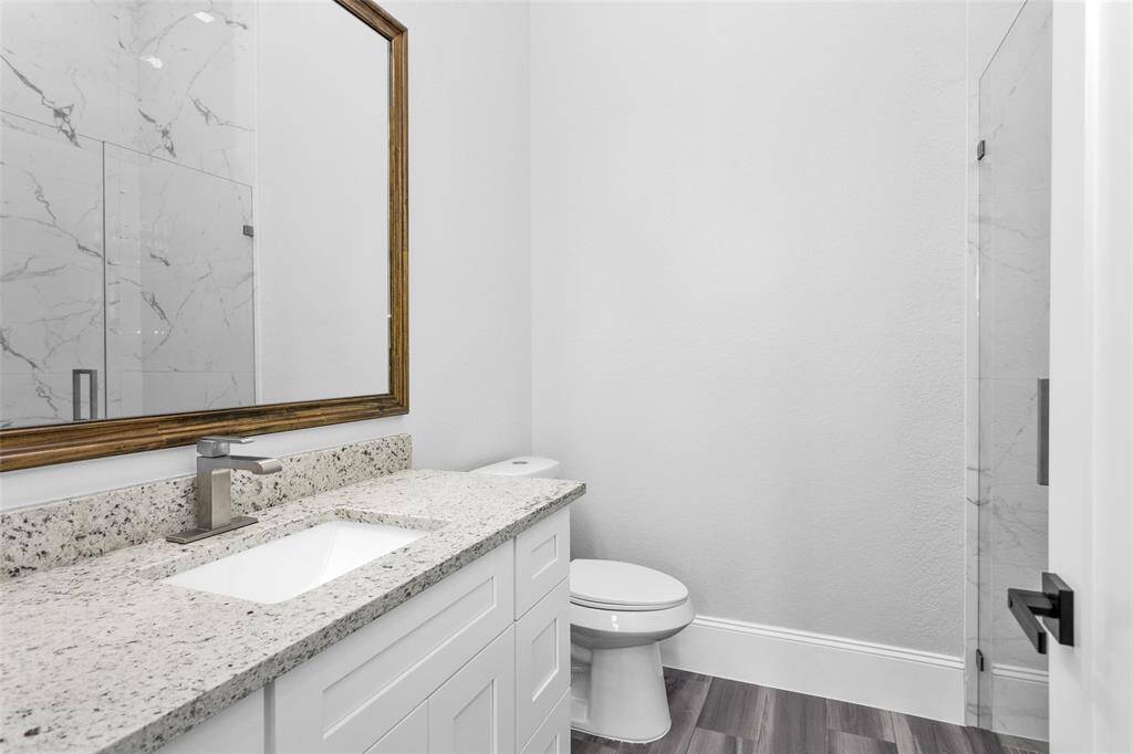 Bathroom #6. All Secondary Bathrooms offer walk-in showers with frameless glass and large inset storage and the same clean modern finishings used throughout the home, along with Delta sinks, faucets and shower shower finishings.