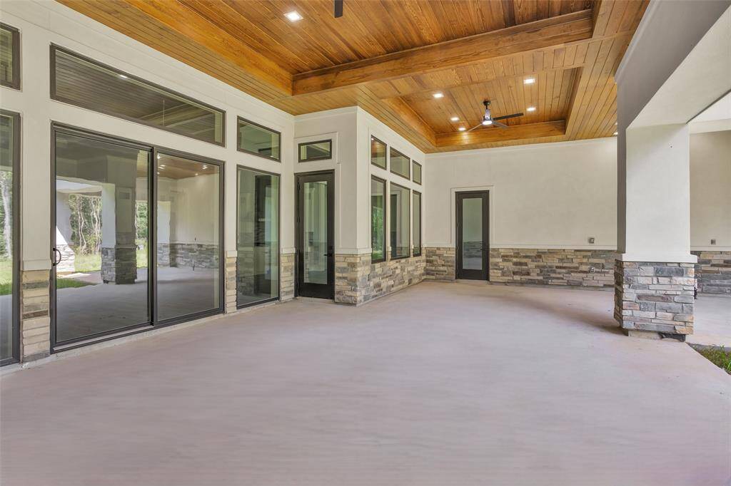 Outdoor living space offers an incredible amount of space for outdoor living, along with beautiful coffered ceilings finished with southern yellow pine ceilings and ceiling fans.