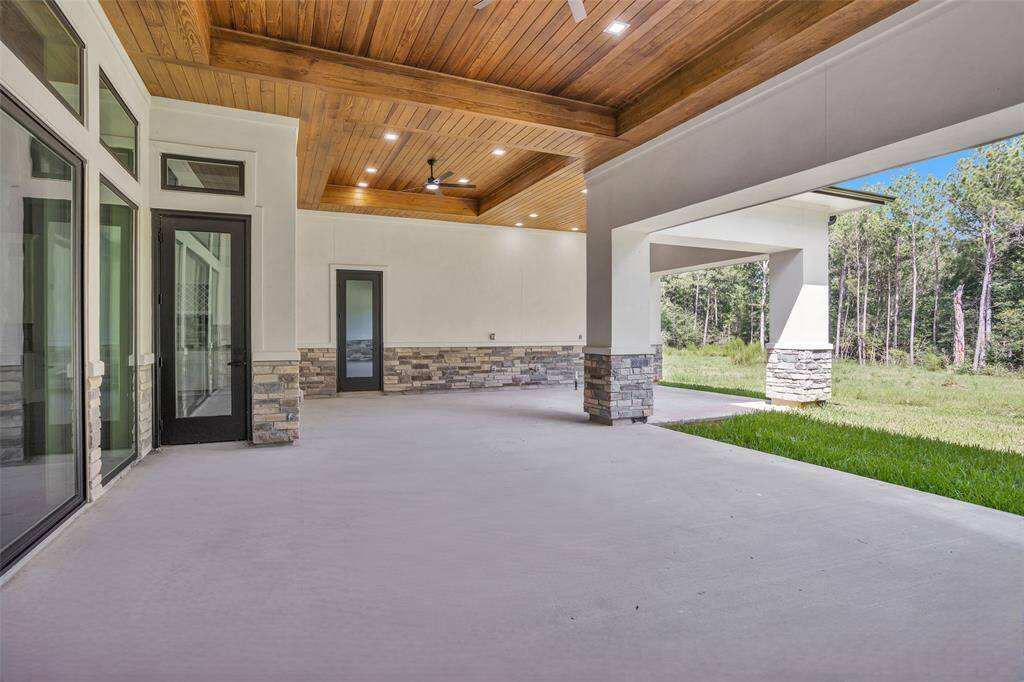 L-shaped outdoor covered patio offers a dedicated space for the Outdoor Kitchen and outdoor living space and would provide a wonderful gateway to a swimming pool!