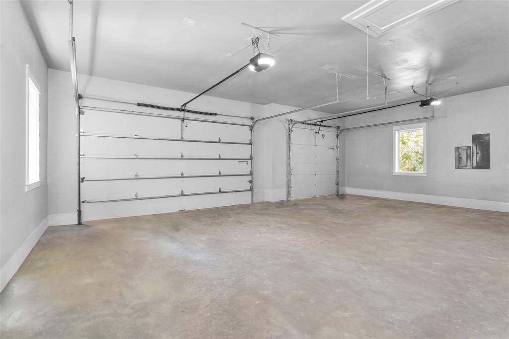 Huge 3-car garage is 33'8" x 21'6" with 9' ceilings, and attic access. Garage doors are 16'x9' and 9'x9'.