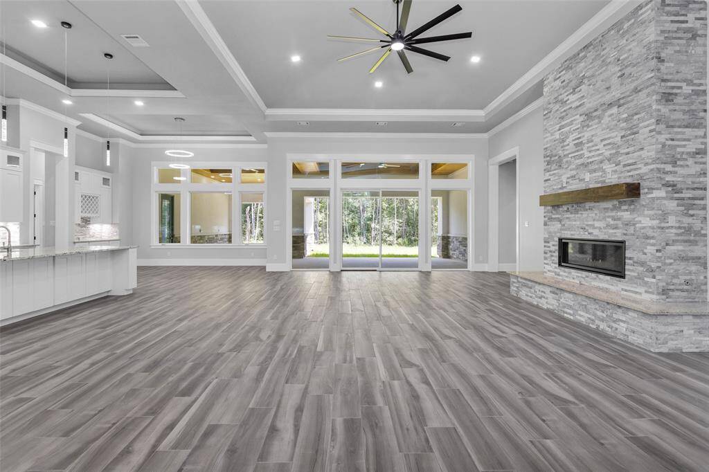 Kitchen, Dining Room & Family Room feature architectural tray ceilings and are bathed in natural light from the abundant glass doors, windows, transoms, inset lighting and chandeliers.