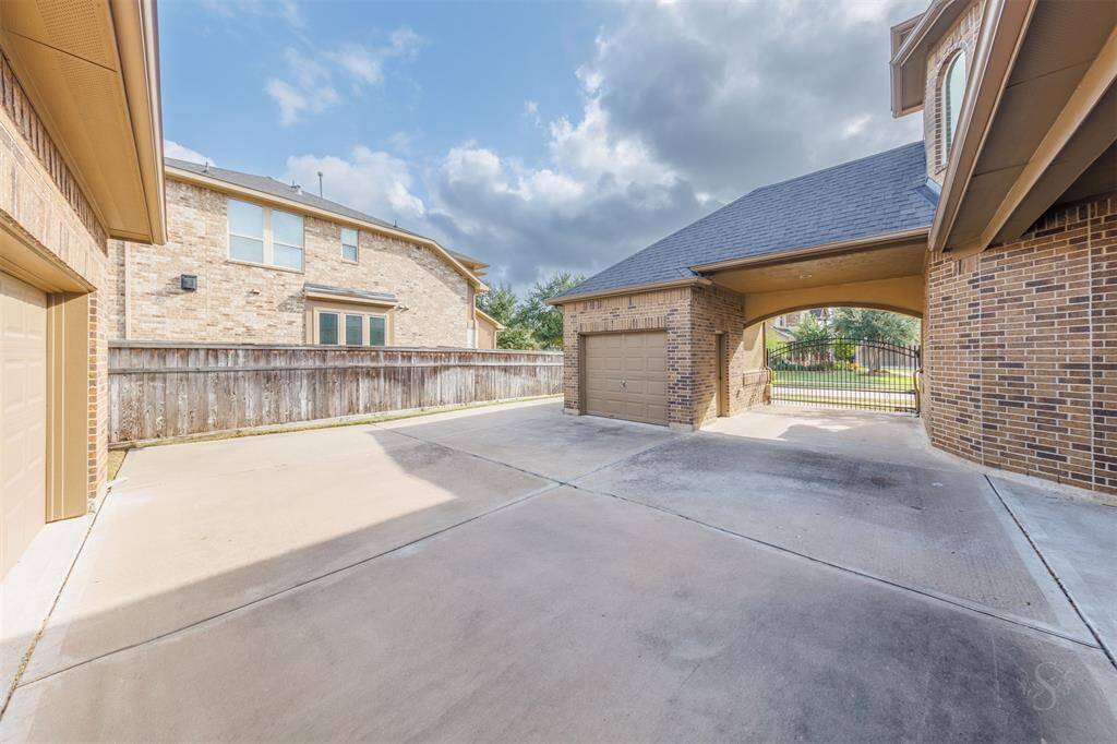 Once inside the remote access security gates, you'll find this internal courtyard which provides access to a 2 car and 1 car separate garage! Besides lots of extra parking space, this would be a great space for little ones to play behind the security gate for safety. It would also make a great basketball court!