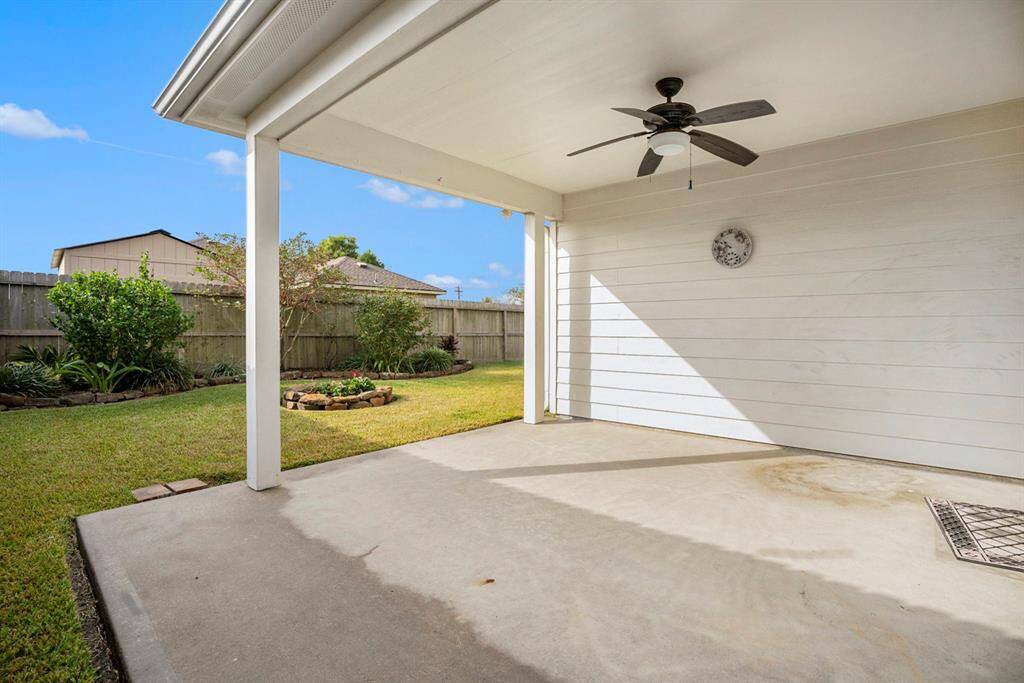 The Covered patio porch with ceiling fan Note the double frenc doors with the electric Storm Shutter
