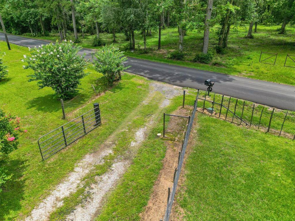 DRIVEWAY WITH VIEW OF THE GATED ENTRY.