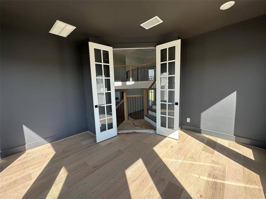 Chef's Kitchen with luxurious finishes and large island, opens to the Breakfast Area and Family Room with French doors leading to the back patio perfect for entertaining indoors and out.