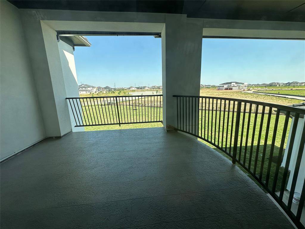 Two-story Family Room with stunning floor to ceiling stacked windows to let lots of light in with linear fireplace creating a great space to gather & entertain in off of the Kitchen, Breakfast Area, and Game Room. An additional staircase leading to the second floor is included as well.