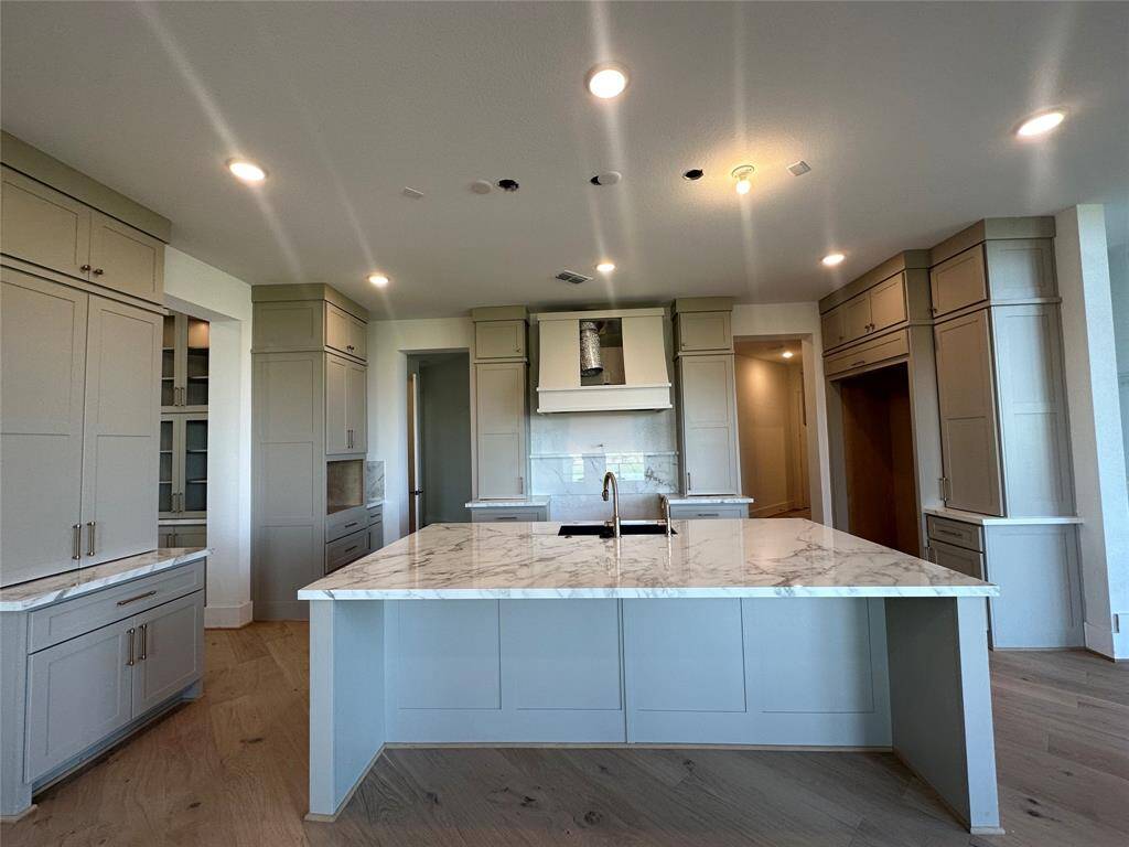 View of the exquisite, elevated Living Room with stacked windows towards the Butler's Pantry, Kitchen and Family Room that's coming along beautifully.