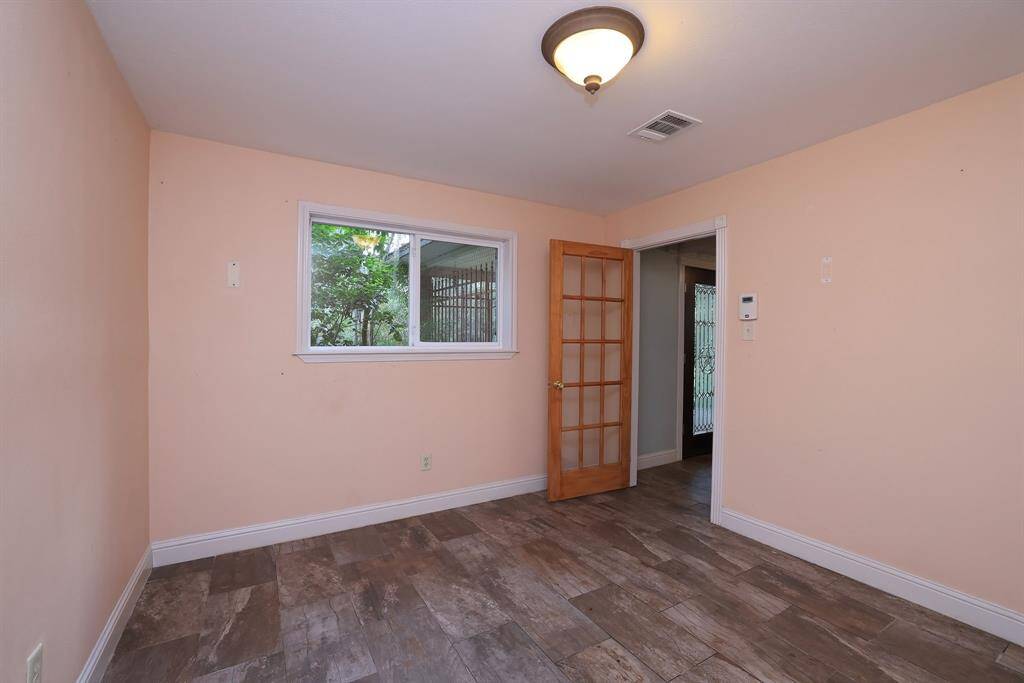 This flexible space can be used as a Home office, downstairs bedroom, 2nd living space, gameroom, or home gym. The large window overlooks the front yard and the French door helps keep the space light and bright.