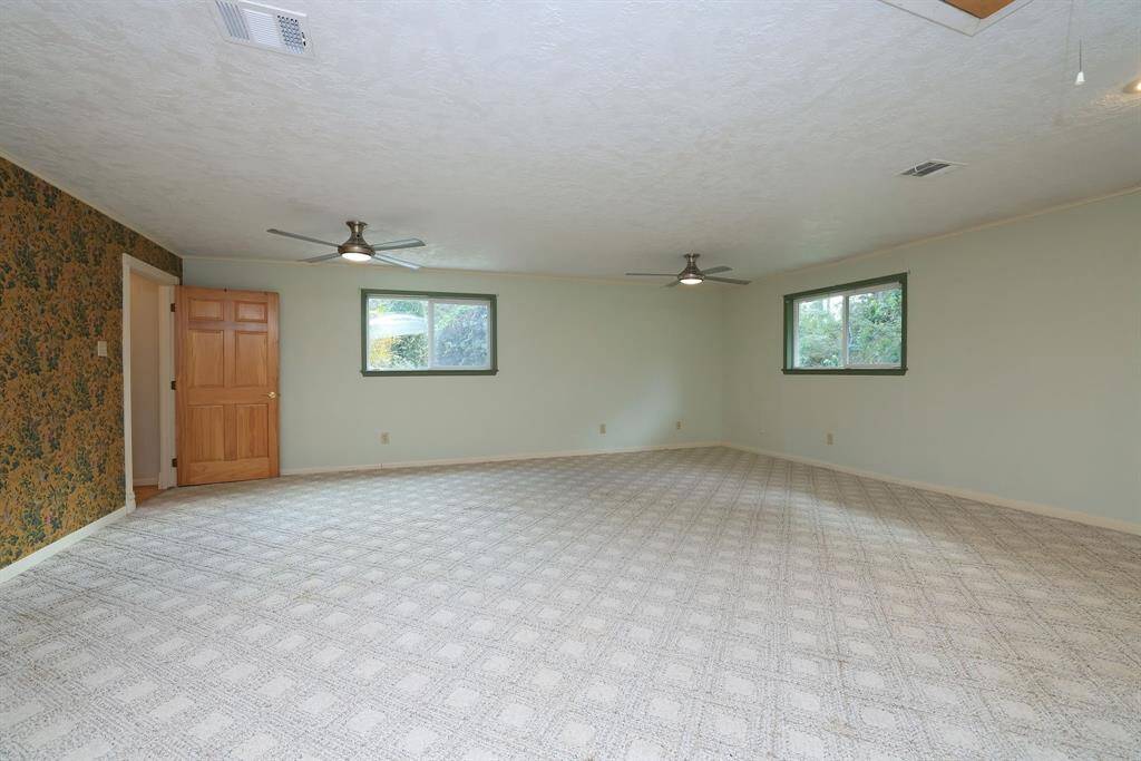 The Master Suite measures approx 23x22 and can become your own private retreat with spaces for a sitting area and workout equipment. Large windows provide natural light and views of the front of the property.