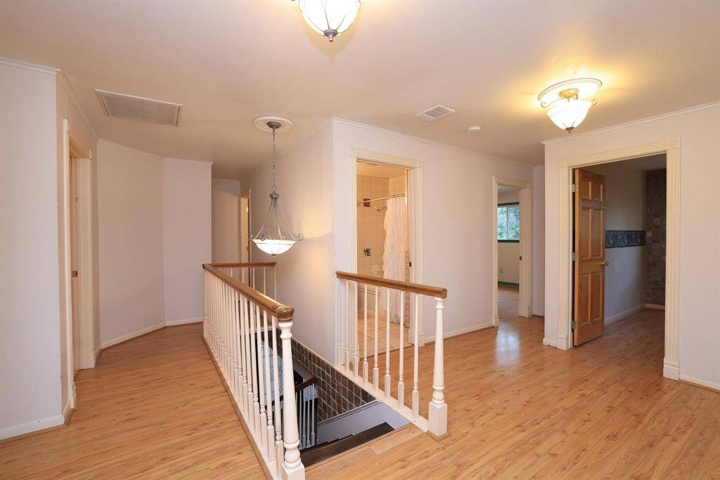 At the top of the front stair case, the large landing open to the 4 secondary bedrooms and the home's 2 Full Baths. There is also a large closet with built-in cabinets at the top of these stairs. You'll love all the storage this home has to offer.