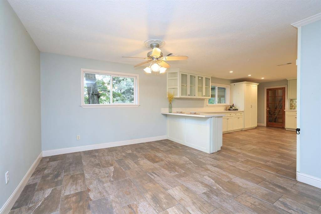 The Dining space measures approx 12x11 and includes a large window with views of the backyard, ceiling fan with lights and built-in doggy gate to separate the dining space from the Kitchen.