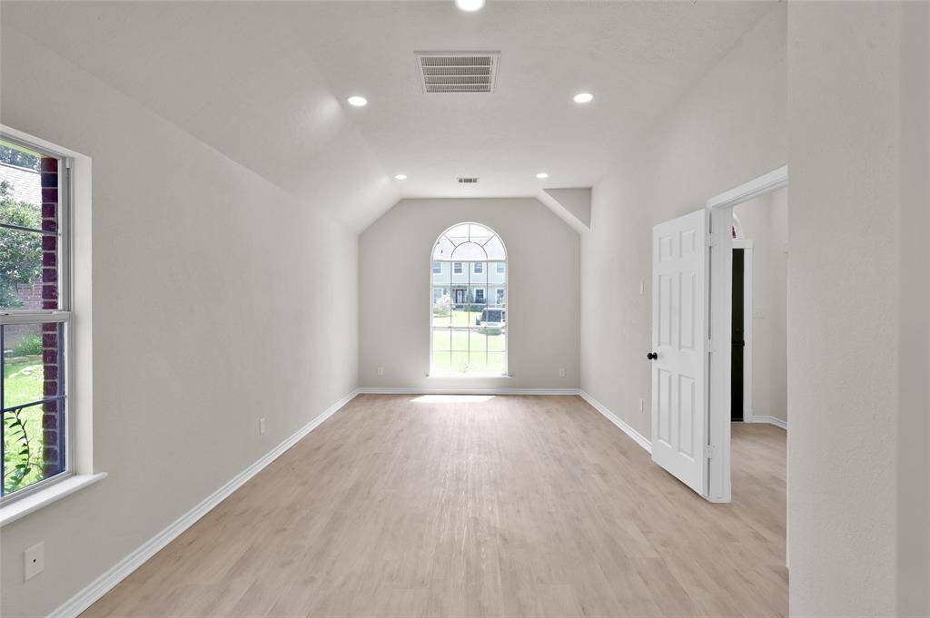 Step inside the Primary/master to be treated by beautiful, new LVP floors that stretch throughout the room, complementing the neutral, elegant color palette. The abundance of natural light streaming through the strategically placed windows accentuates the room's airy feel, while the high ceilings provide a sense of luxurious spaciousness.