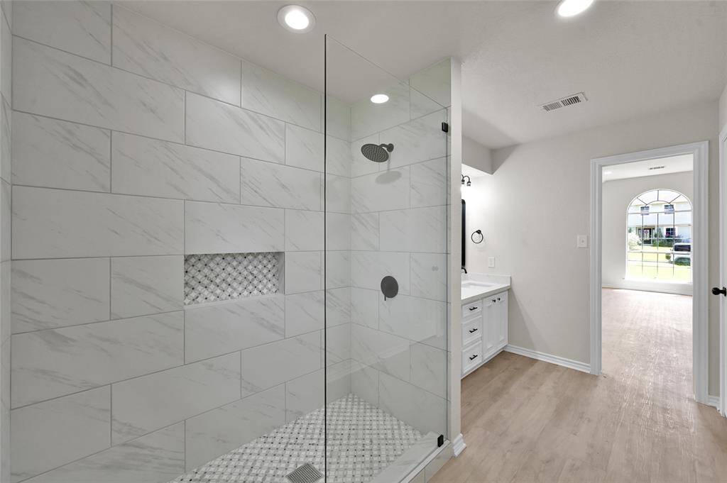 The centerpiece of this bathroom is the brand-new super shower, a true oasis featuring a frameless glass door, premium telework, luxury showered, including a rainfall option , to deliver an unparalleled showering experience!