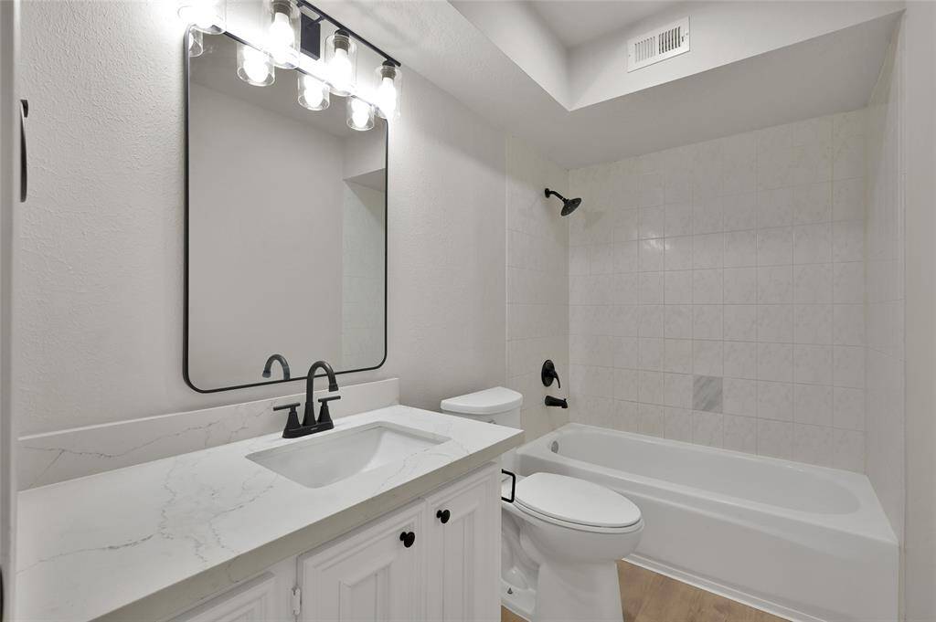 Beautifully appointed main bath with a new oversized quartz vanity.