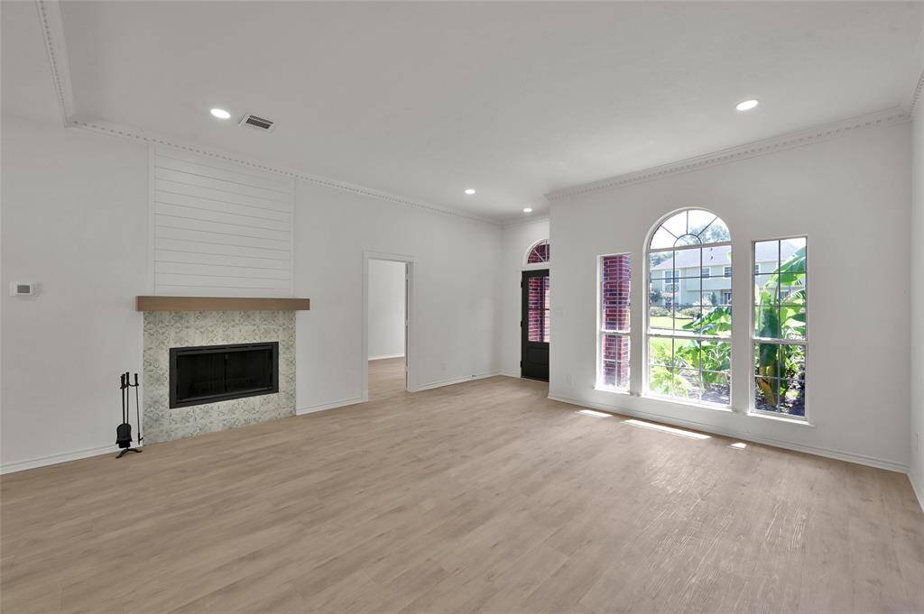 This natural wood fireplace with new tile surround, mantel, and shiplap feature wall will be perfect to enjoy on cooler evenings!
