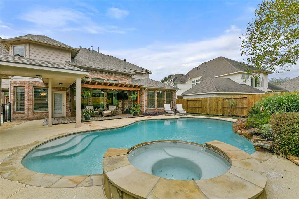 The crown jewel of the backyard is this fabulous saltwater pool and spa with a Pebble Tec finish, a new pool heater, stone coping, stamped concrete decking, a recently replaced stained privacy fence, and tropical landscaping with lighting, an in-ground sprinkler system, and French drains.