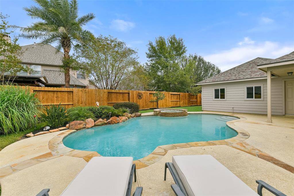 The crown jewel of the backyard is this fabulous saltwater pool and spa with a Pebble Tec finish, a new pool heater, stone coping, stamped concrete decking, a recently replaced stained privacy fence, and tropical landscaping with lighting, an in-ground sprinkler system, and French drains.