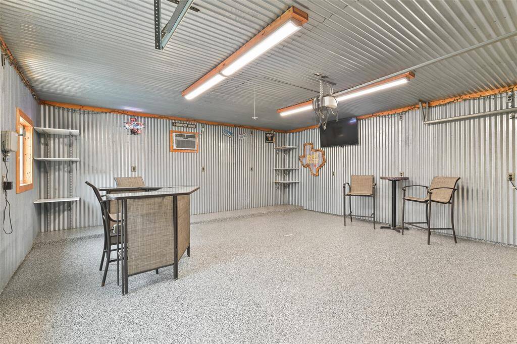 Fully finished man cave which can be used for a workshop and extended entertainment area. Includes epoxy floor and metal walls/ceiling.