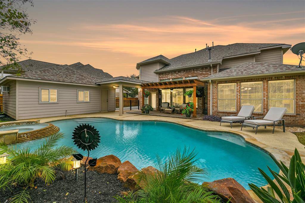 The crown jewel of the backyard is this fabulous saltwater pool and spa with a Pebble Tec finish, a new pool heater, stone coping, stamped concrete decking, a recently replaced stained privacy fence, and tropical landscaping with lighting, an in-ground sprinkler system, and French drains.
