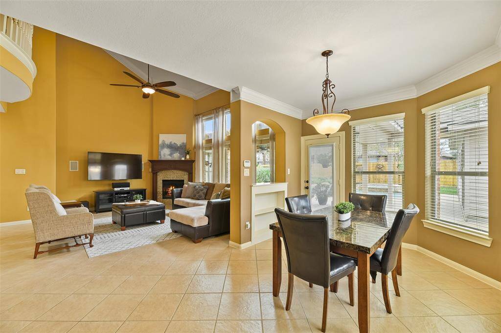 The main living space flows seamlessly into the adjoining breakfast room and island kitchen, where you'll find a full-panel glass door to the back patio and bay windows that overlook the peaceful paradise in your own backyard.