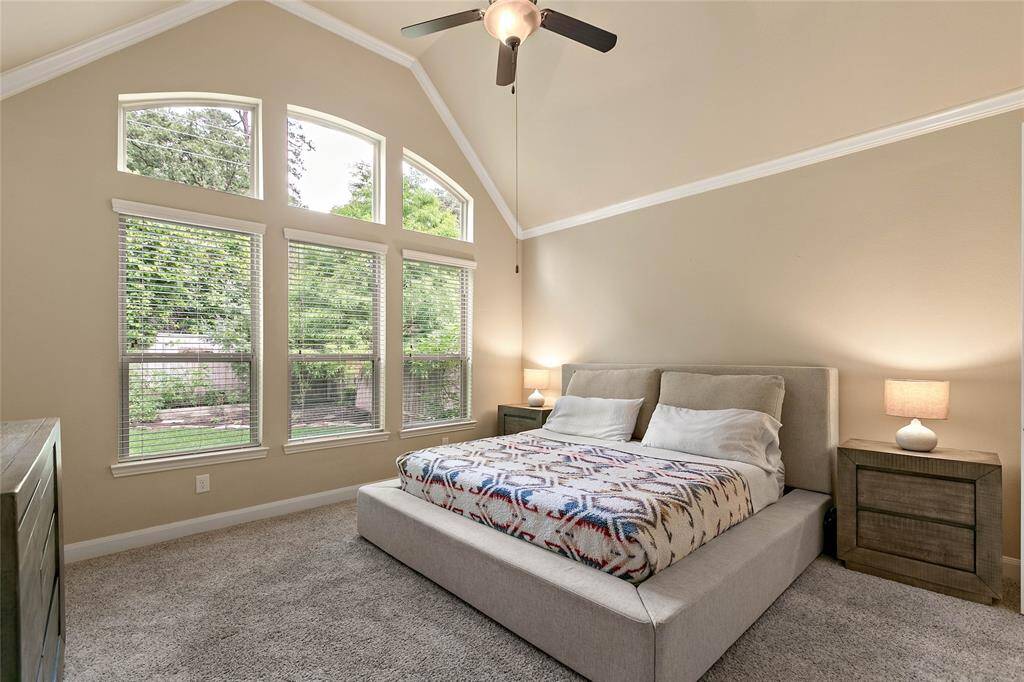 Spacious primary bedroom with high ceilings.