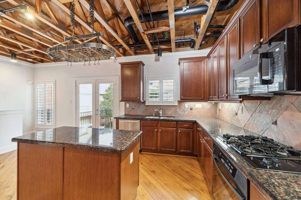 Off of the kitchen is a balcony along with a propane grill that will be sold with the home.