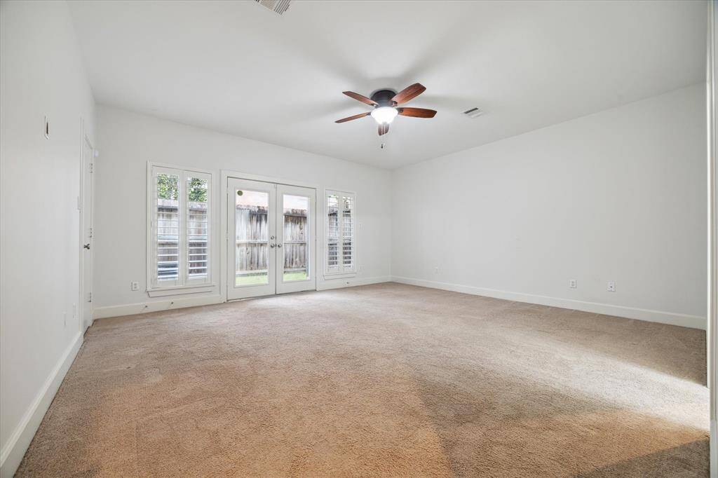 The main, traditional style bedroom is downstairs off of the kitchen. A spacious closet, patio, and en suite bathroom are connected to this room.
