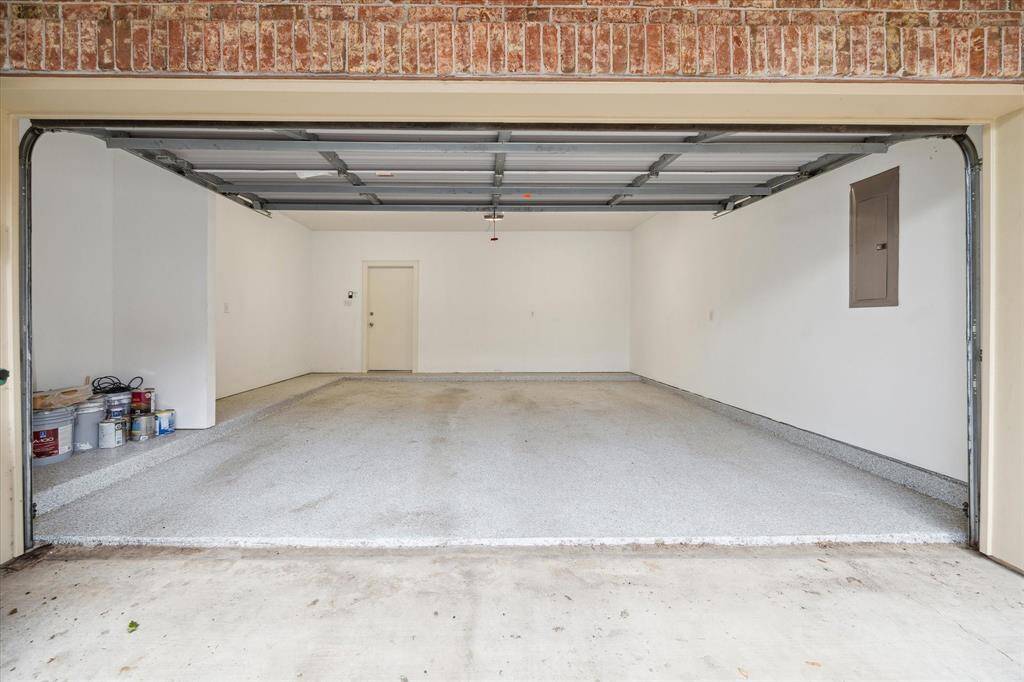 The garage has stylish epoxy flooring and space dedicated to extra storage.